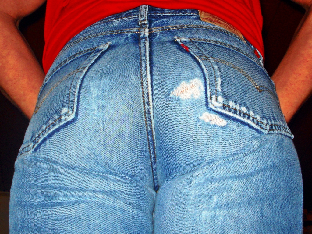 someone is showing off their jeans with a toothbrush in their mouth