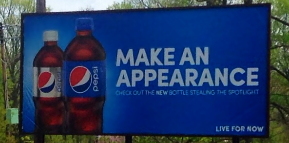 a pepsi advertit is on a blue billboard sign