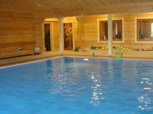 an indoor pool with several chairs on it