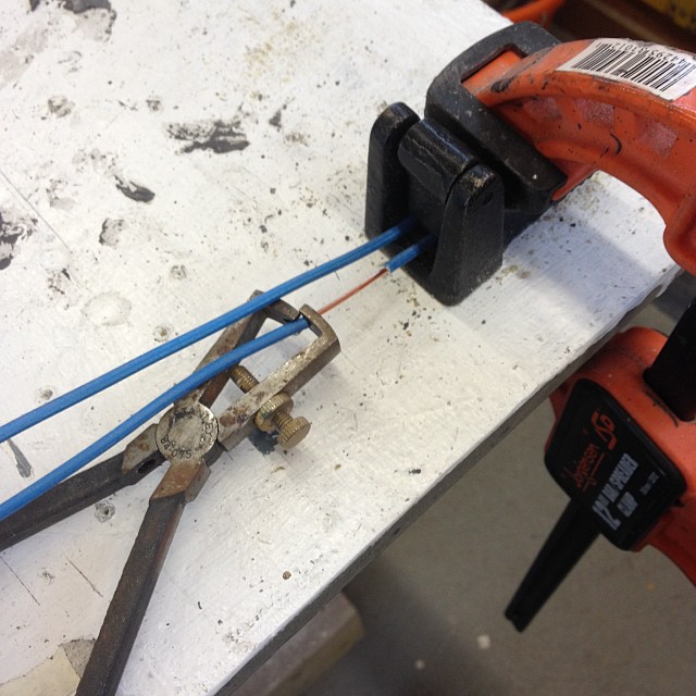 a pair of construction tools, a wrench and pliers on a work bench