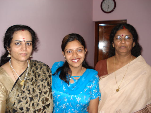 three women are wearing blue and smiling at the camera
