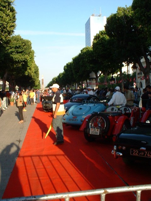 car show with red carpet and classic sports cars