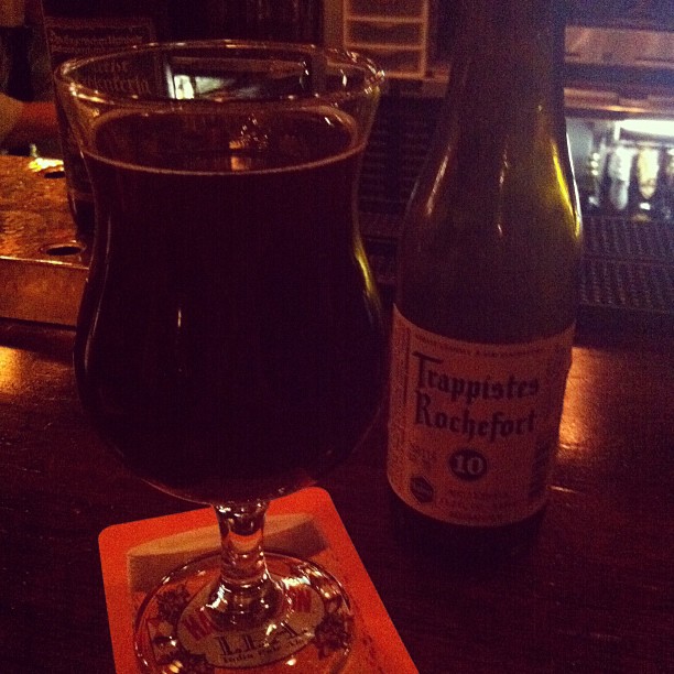 a wine glass and beer bottle are sitting on a table