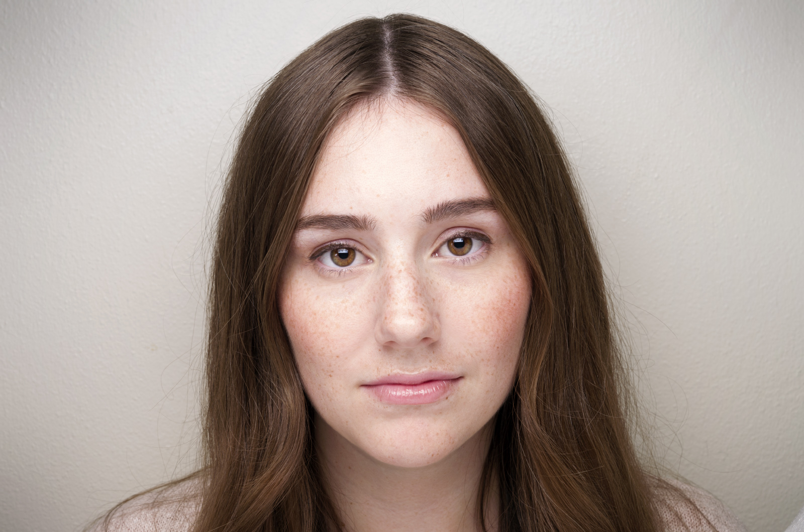 a woman with long hair has her eyes wide open