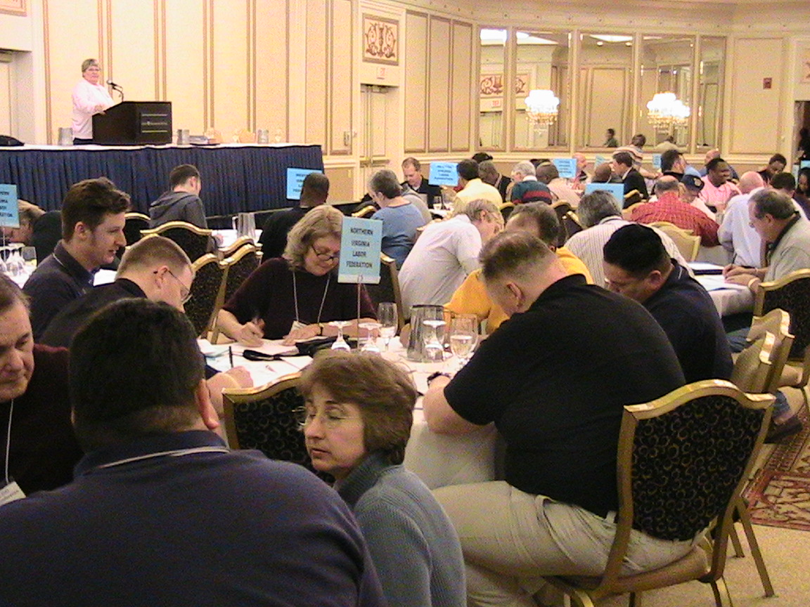 a large room filled with people sitting at tables