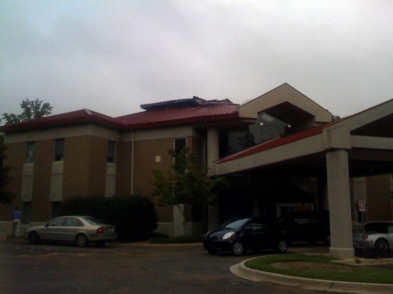 a large el building with cars parked at the entrance