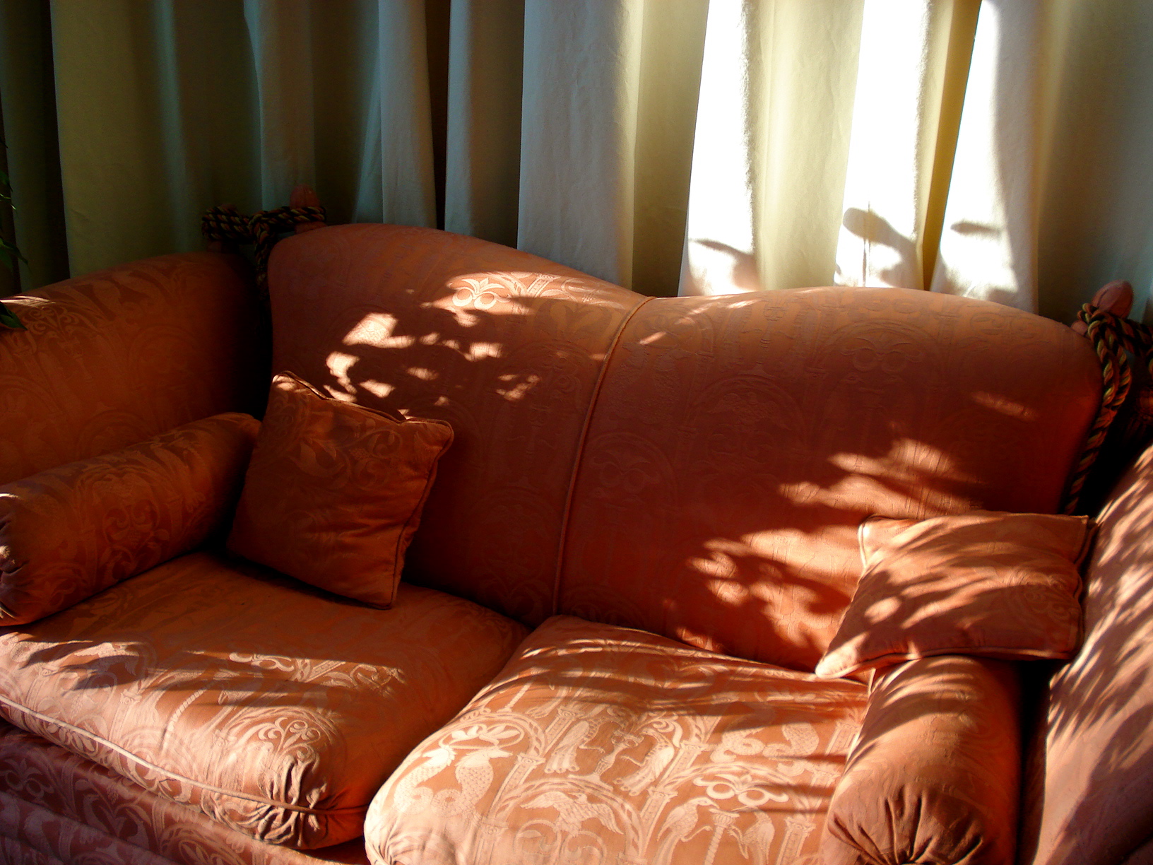an upholstered couch and two matching cushions
