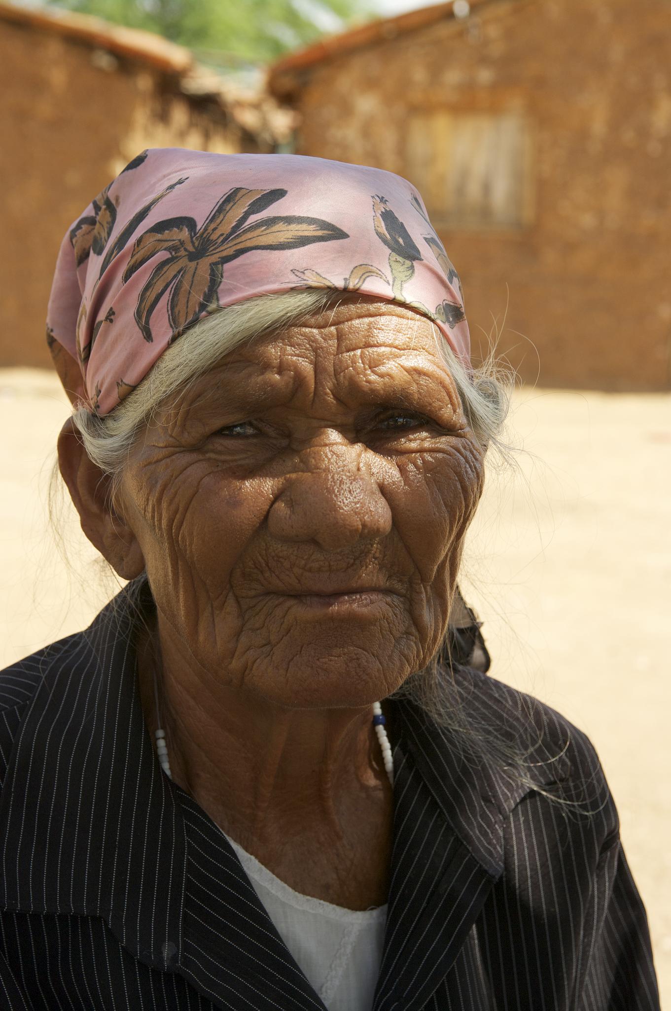 an old woman with a pink headband on