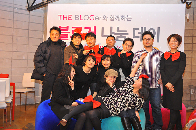 a group of people posing together in front of a sign