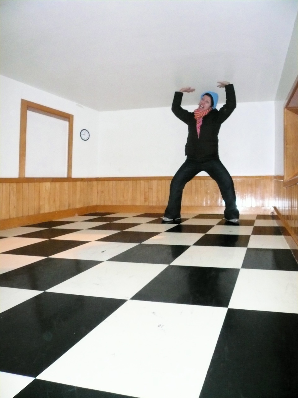 a man in a suit stands in a large floor