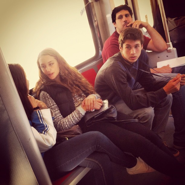 a group of people are sitting together on a bus