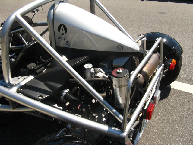 the front of a custom motorcycle, with a seat on it