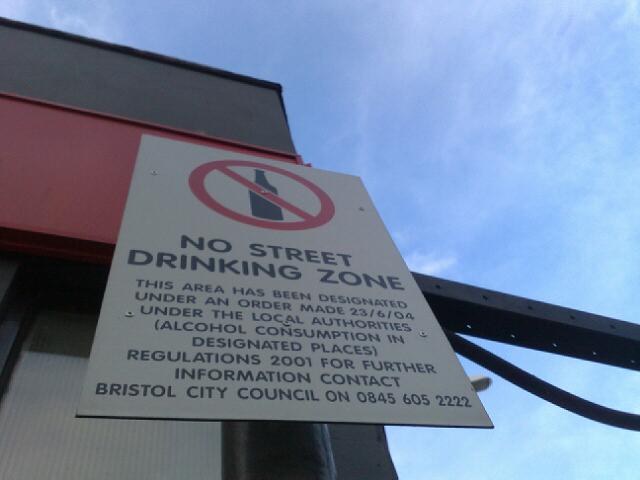 there is a no street drinking zone sign posted to a pole
