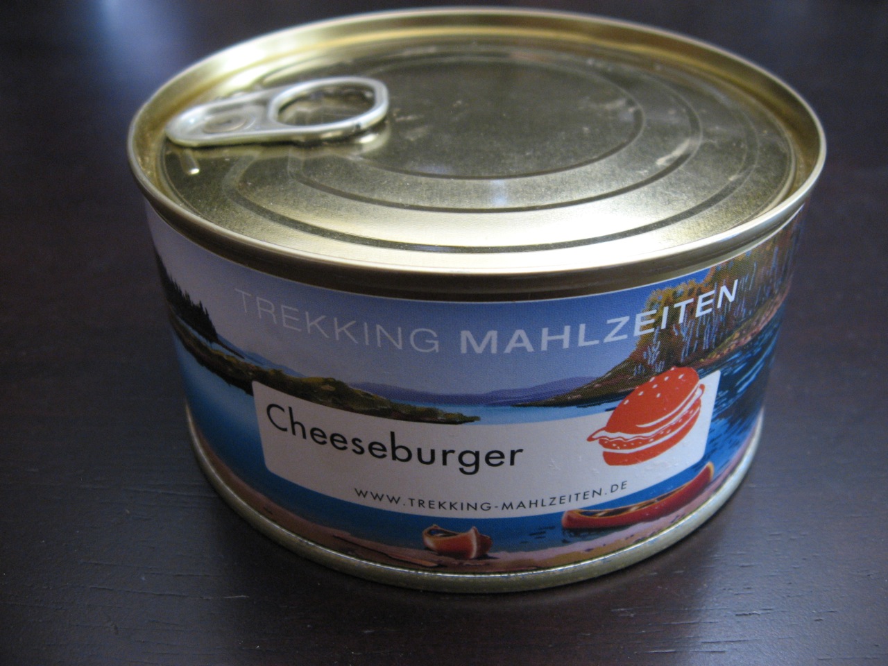 an open can of cheeseburger on a brown table