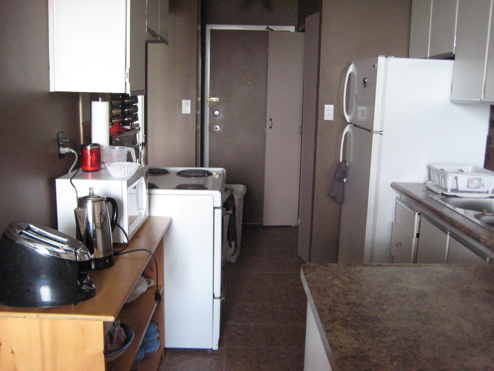 a kitchen is shown with a refrigerator and microwave