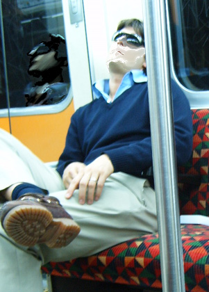 a man wearing sun glasses rides on a train