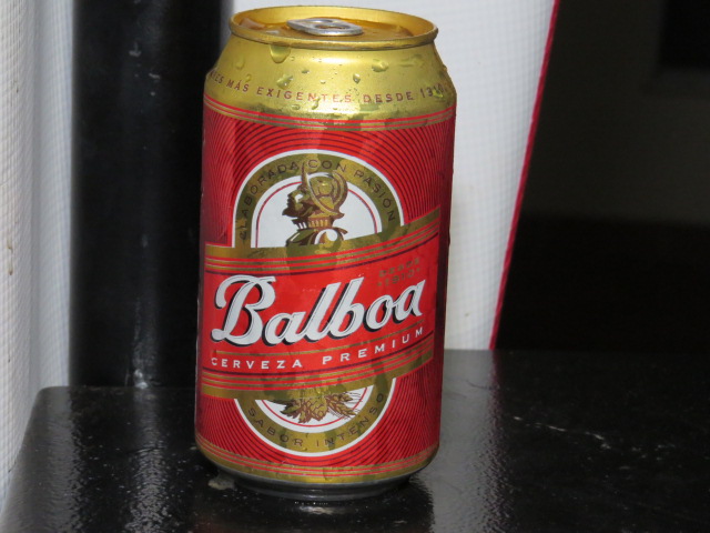 an open can of beer on a black counter top