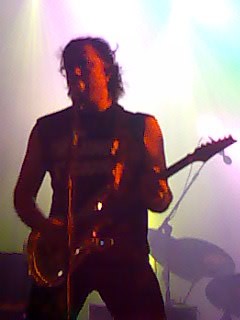 a man standing on stage with his arms out to the side