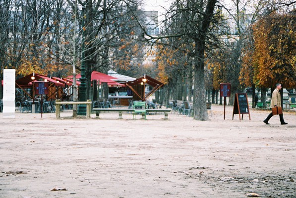 a park covered in dirt with lots of picnic tables