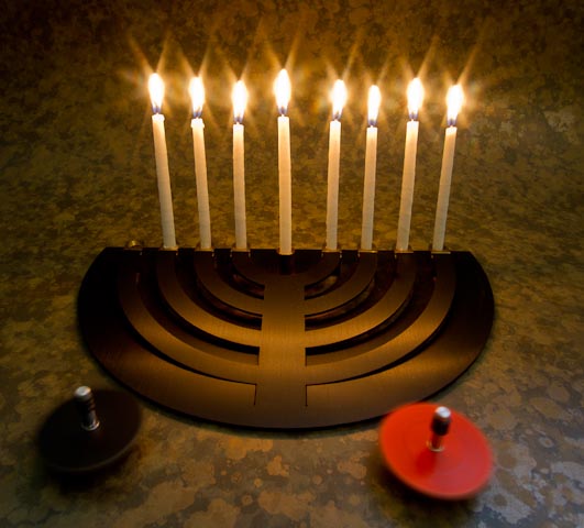 a group of seven candles sitting on top of a circular metal object