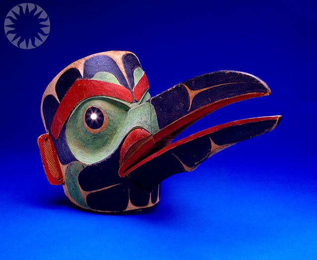 a wooden mask with different designs on it