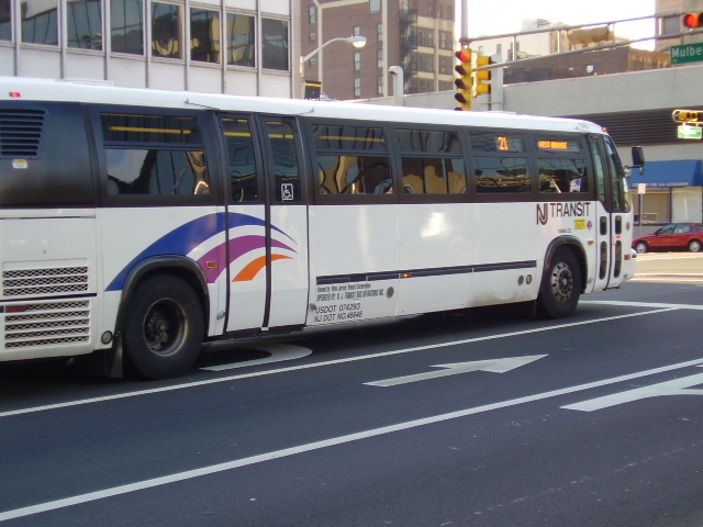 a bus driving through an intersection near a building