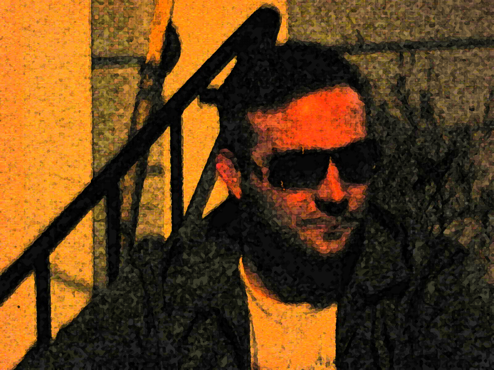 a man in sunglasses is standing near stairs