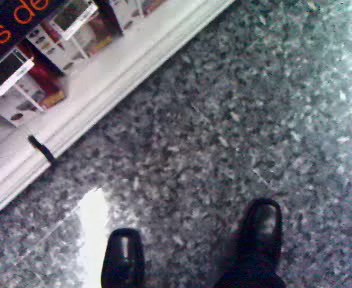 an empty counter with a person in high heels on the floor