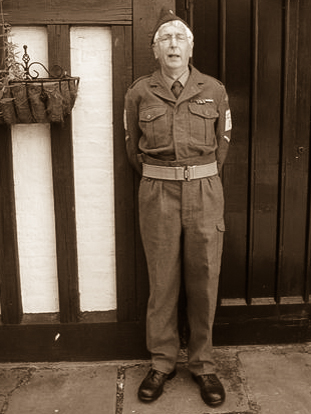 a man with a uniform is standing in front of the door
