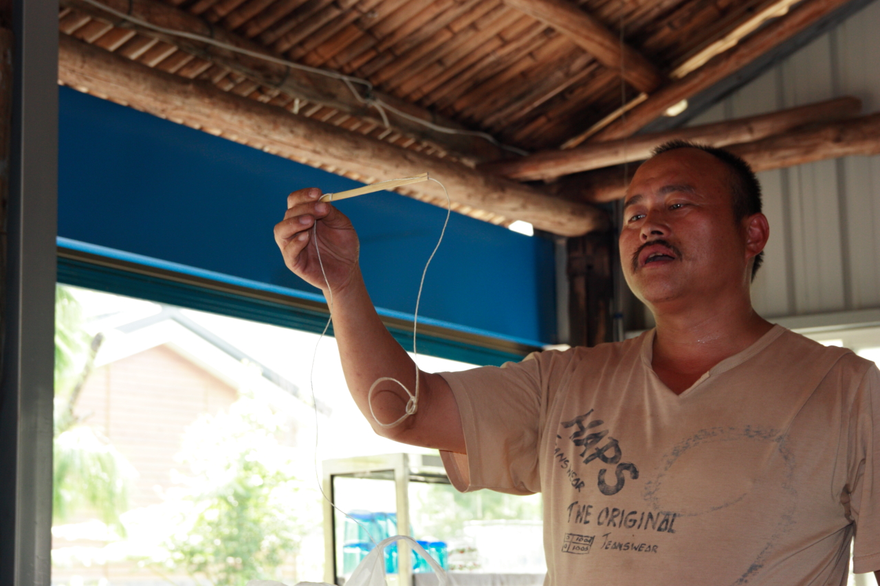 a man holding a string on an outdoor area