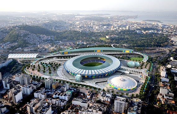 an aerial view of a soccer stadium sitting above the city