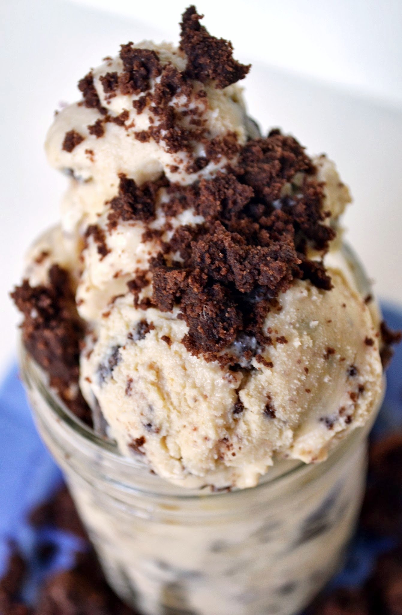 three chocolate cookies and cream dessert in a glass with milk
