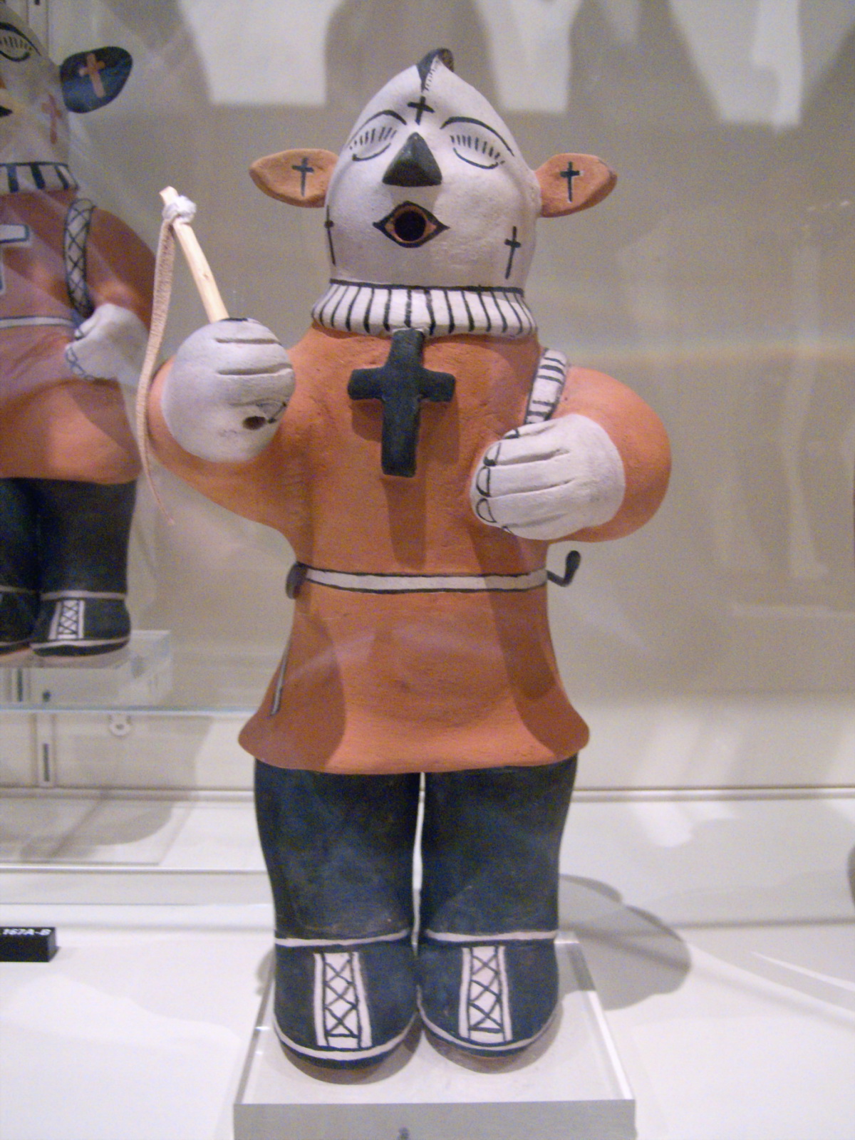 several ceramic figurines including a person wearing an orange outfit