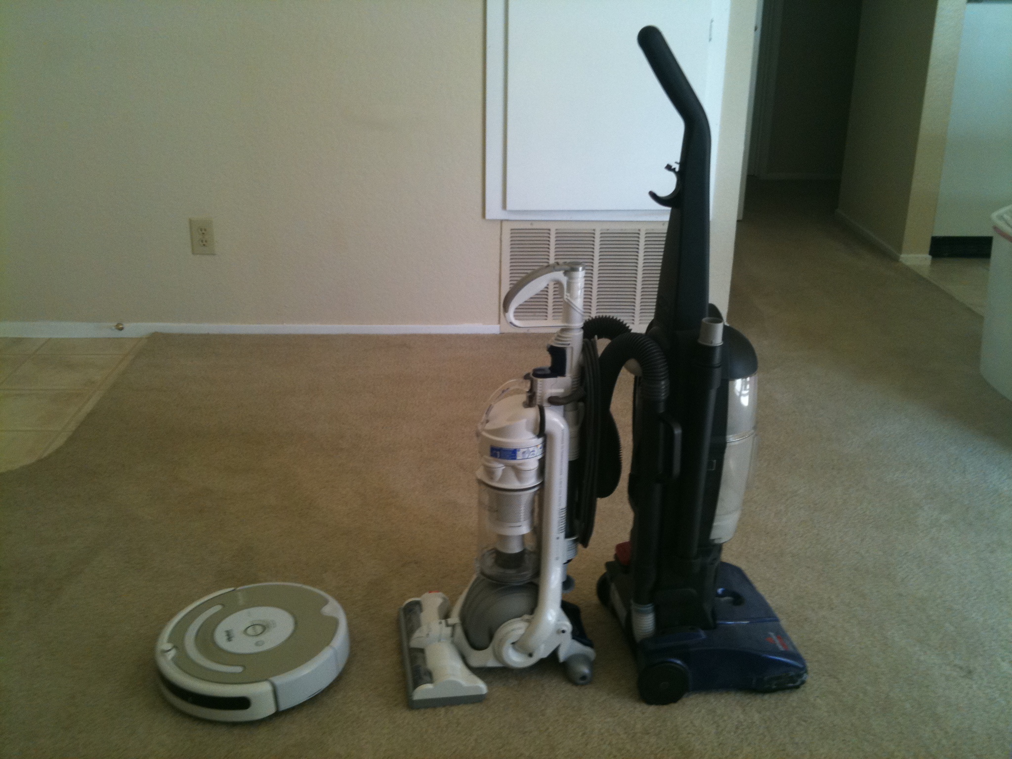 a very clean room with two vacuums next to it