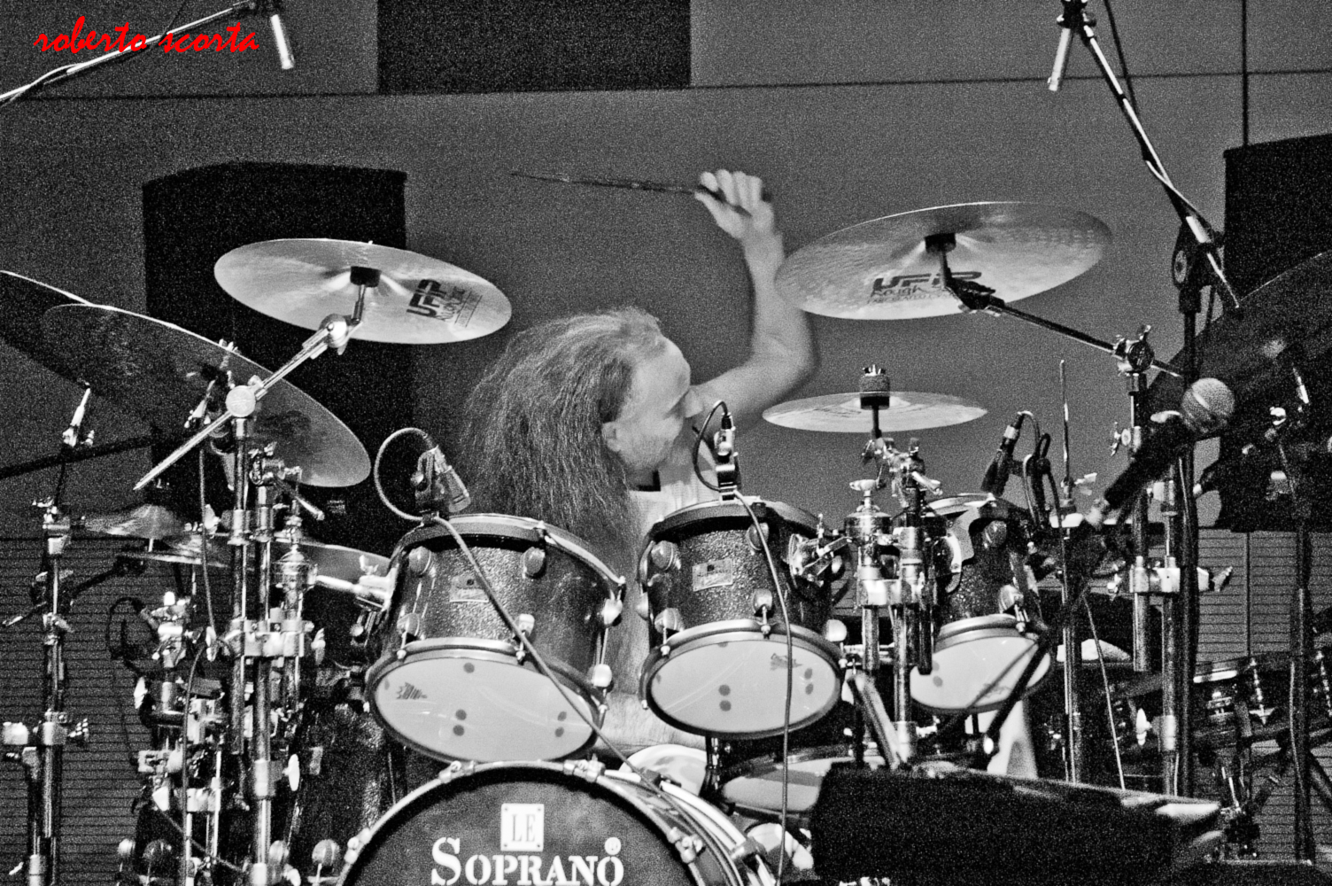 a black and white po of a man on stage playing drums