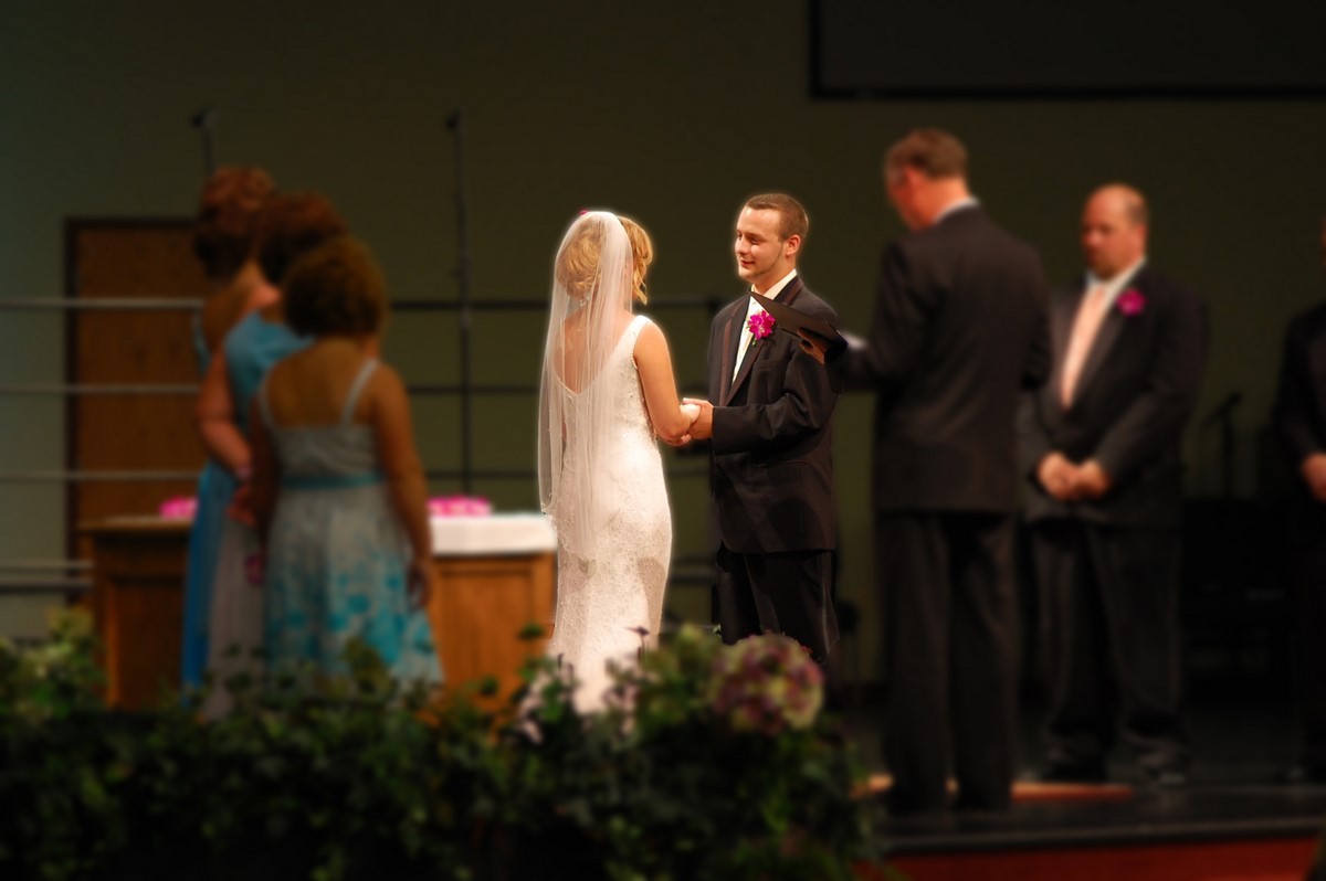 a wedding couple getting married in front of an audience
