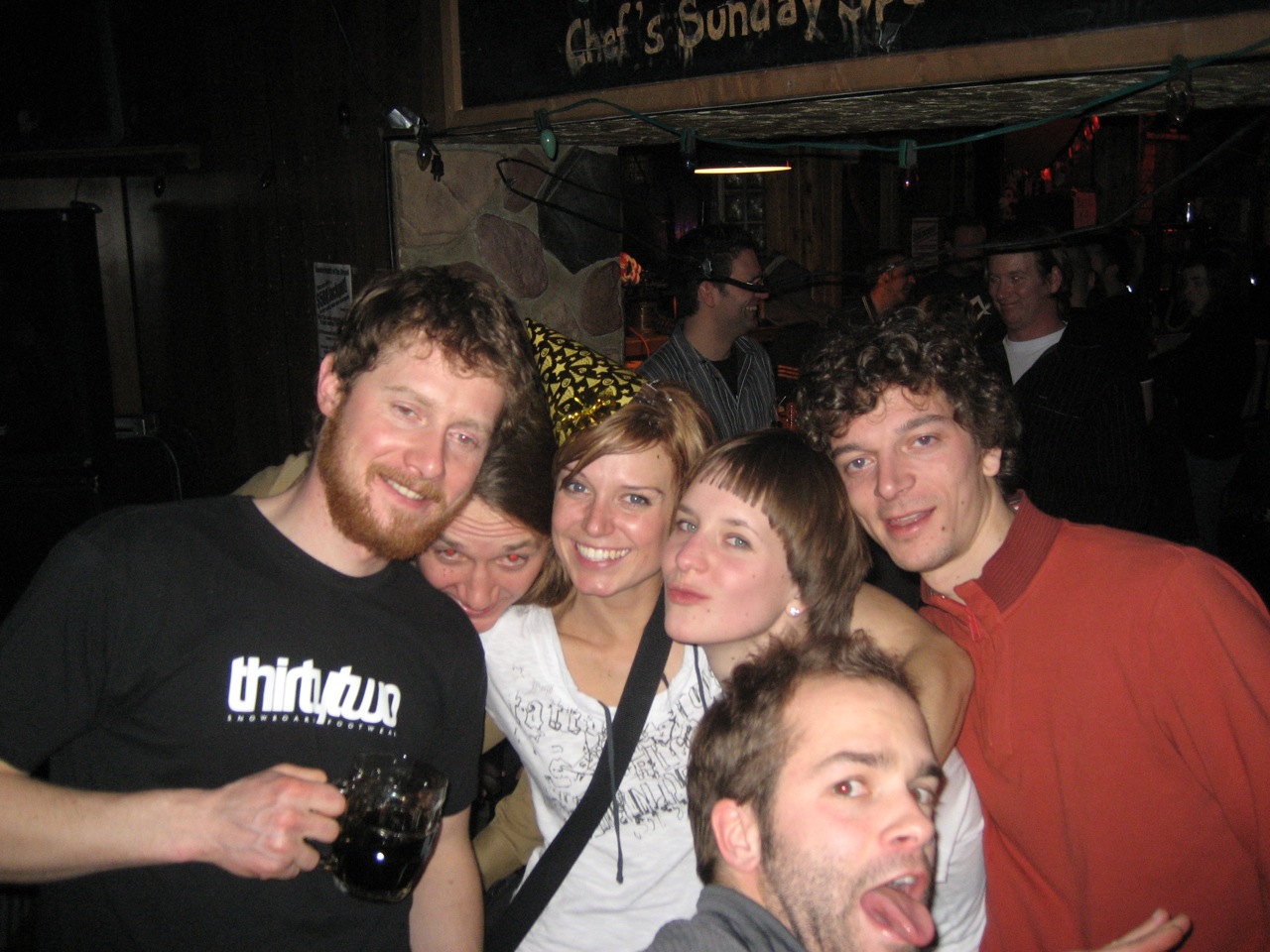 a group of people posing together in a room