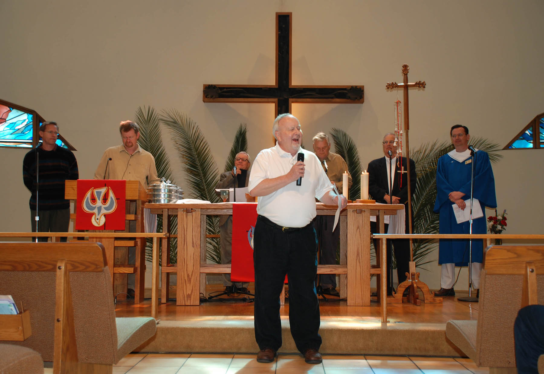 a man speaking at a congregation during a service