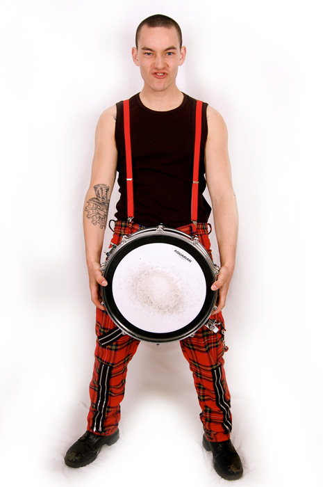 a man holding a white drum while standing