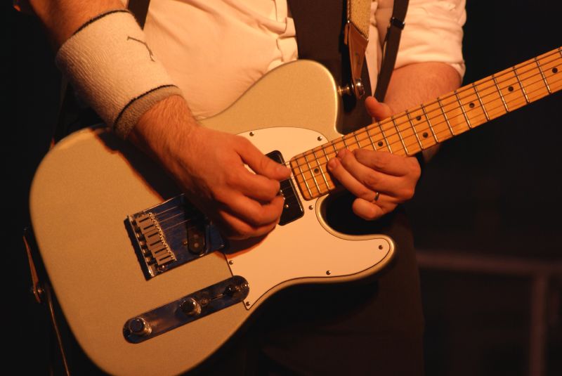 a man that is holding some kind of guitar