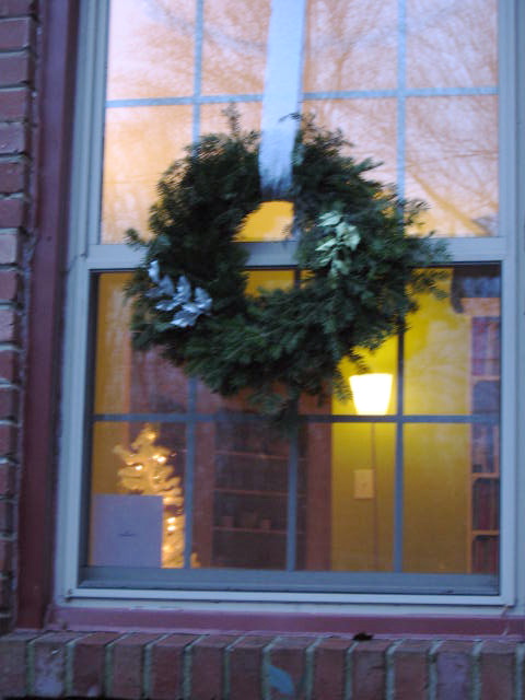 the window of a building with a wreath in it