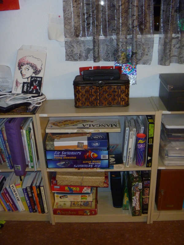 a shelf in the corner of a room filled with books