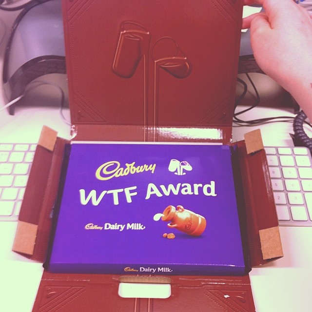 a cake with the word wif award sits in front of a computer keyboard