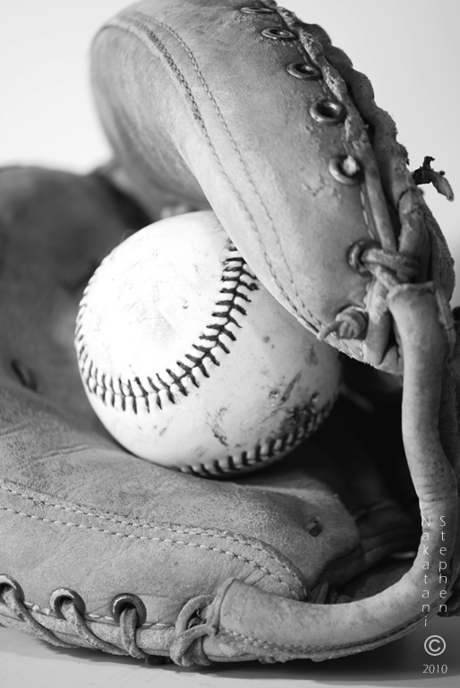 a baseball is resting in the glove of a man