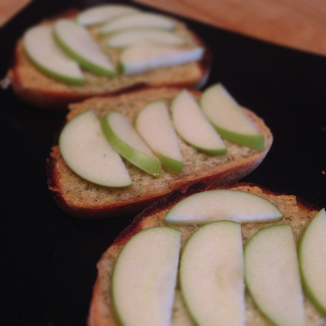 slices of apple are spread out on slices of bread