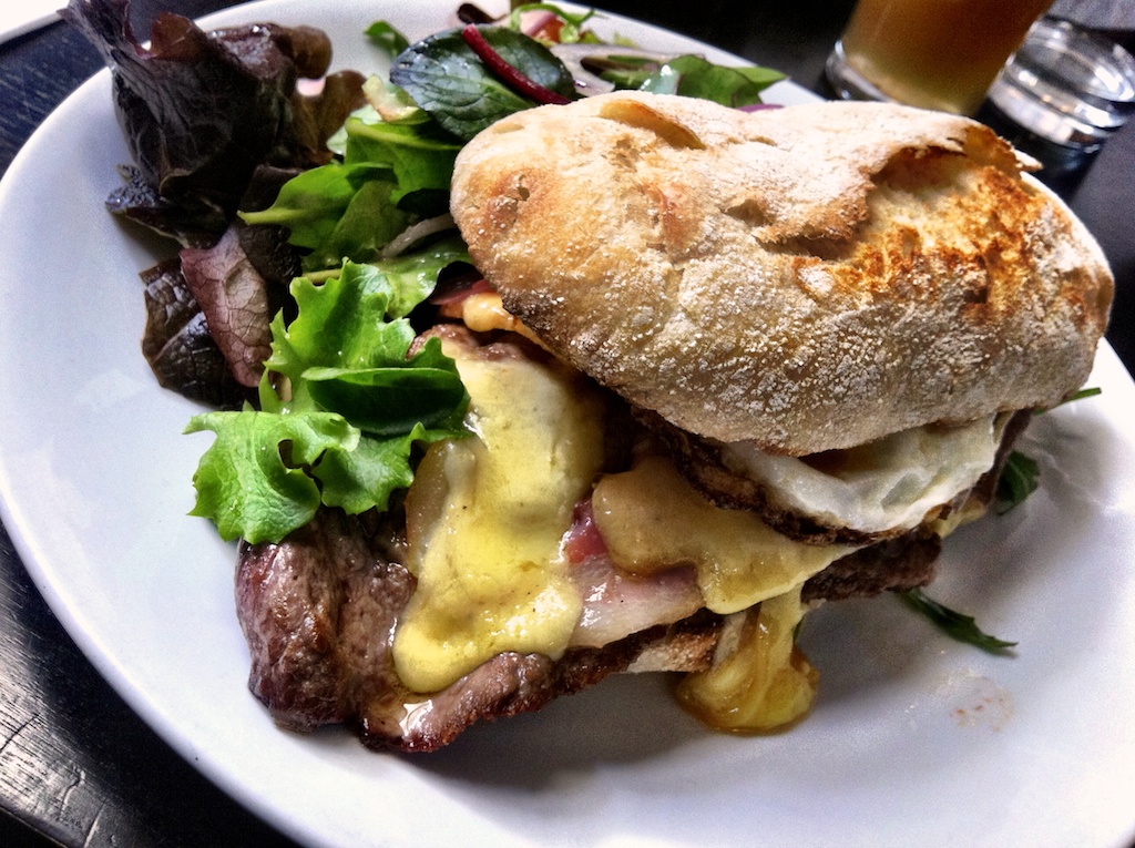 a plate with a sandwich and salad on top