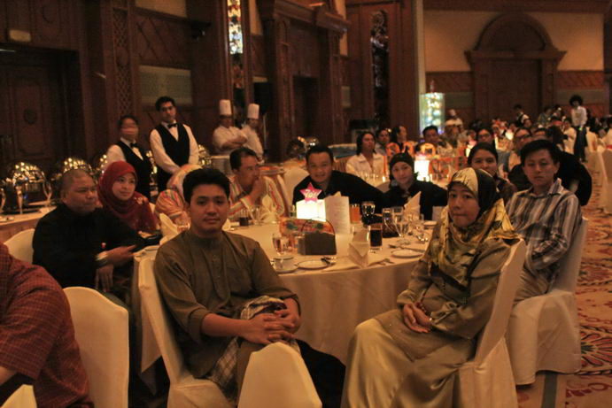 a group of people in formal attire sitting at tables