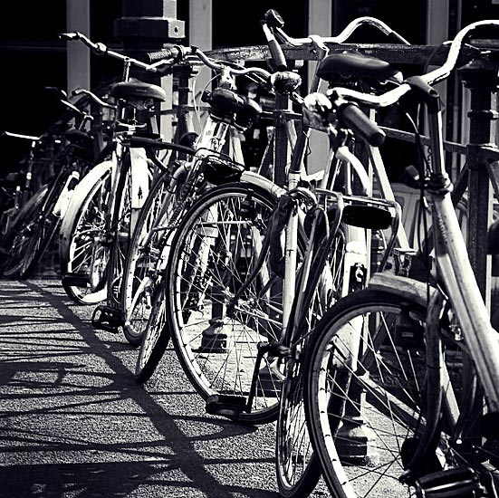 several bicycles parked next to each other in a row