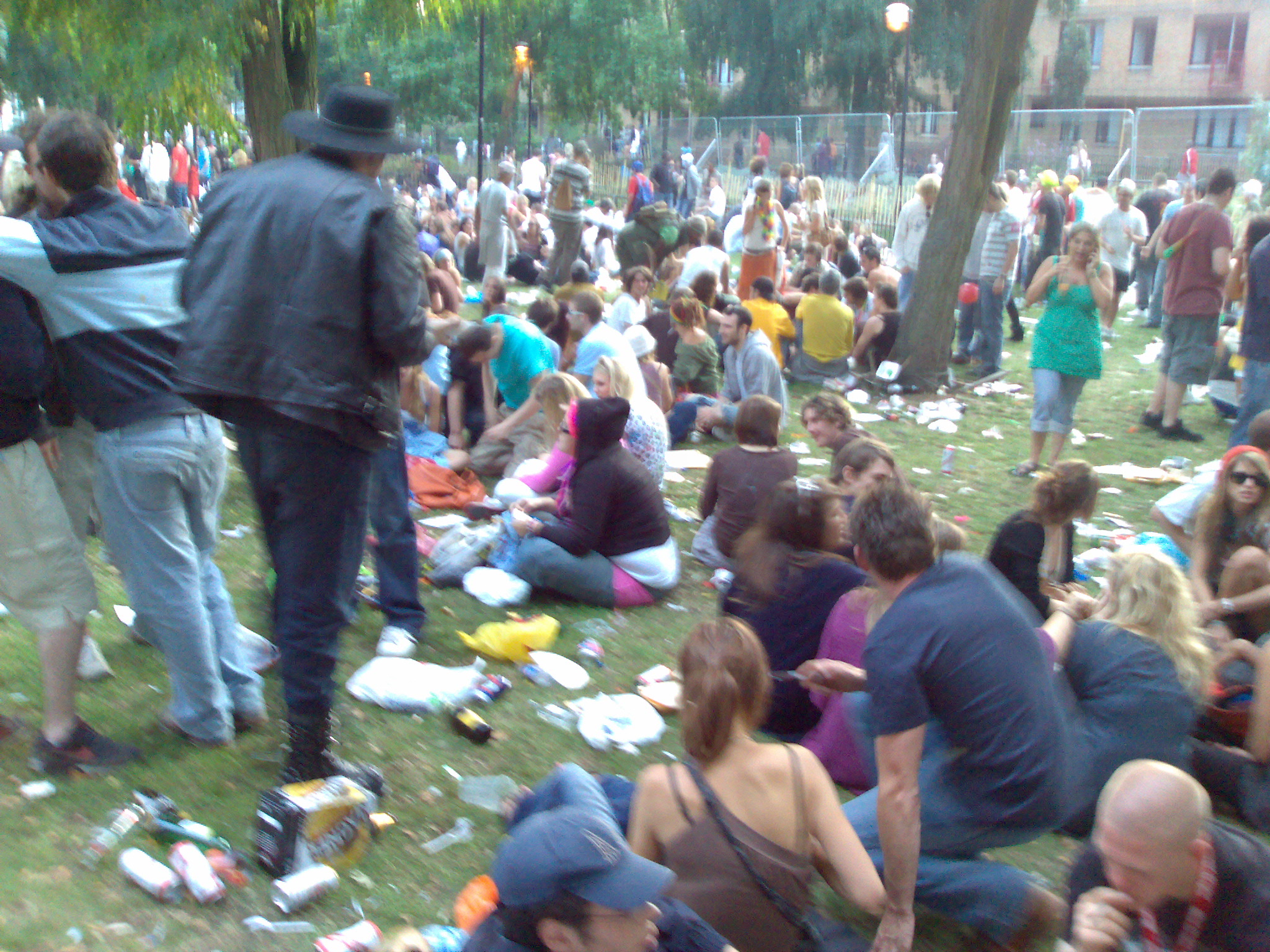 a large crowd of people is gathered in the park