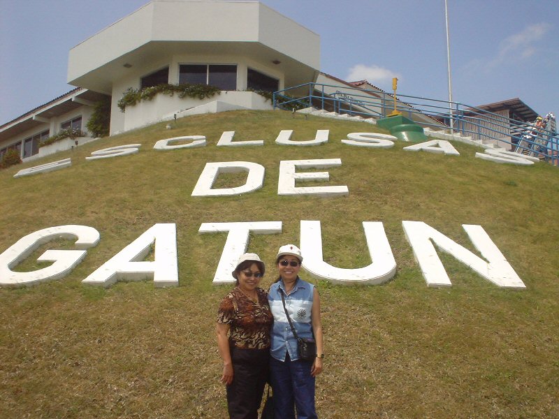 two people posing in front of the famous sign